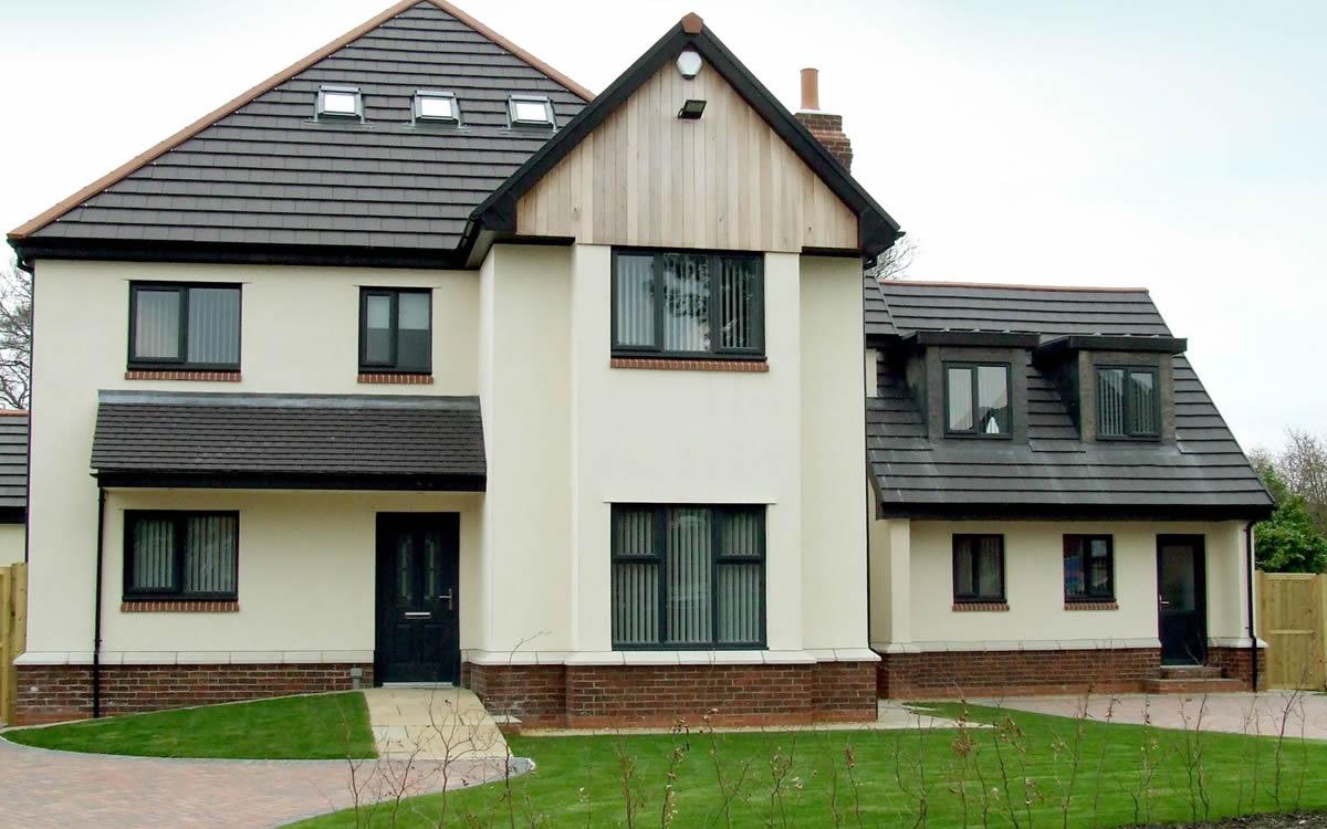 White uPVC windows on a rendered detached house