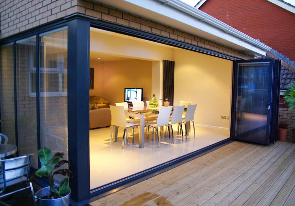 Bifolding doors opening a whole wall onto a garden