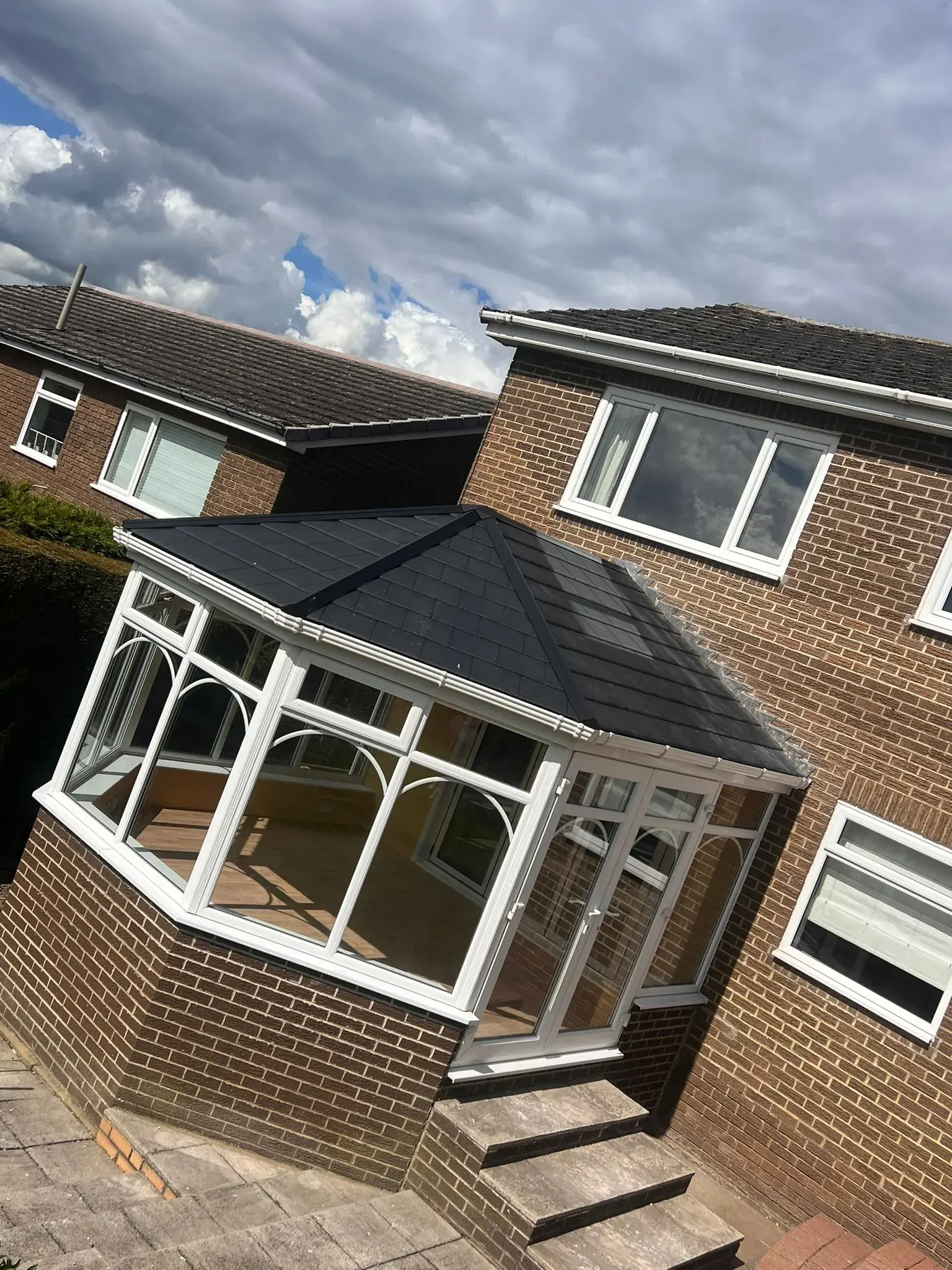 Conservatory fitted with a new slate-grey tiled warm roof