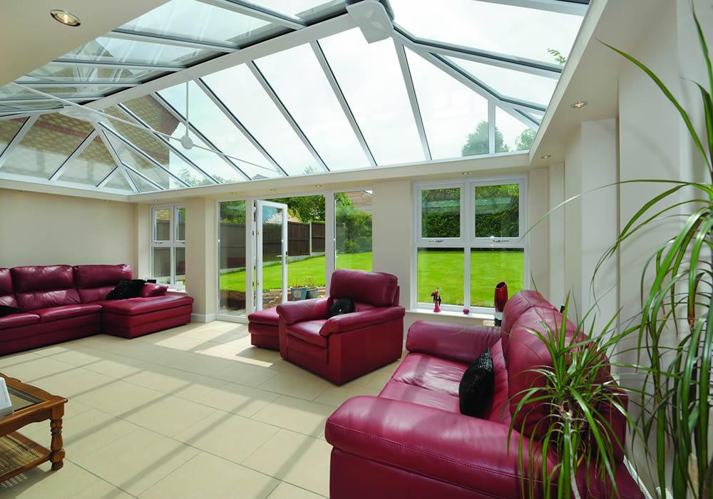 Orangery with brick pillars and a flat glazed roof