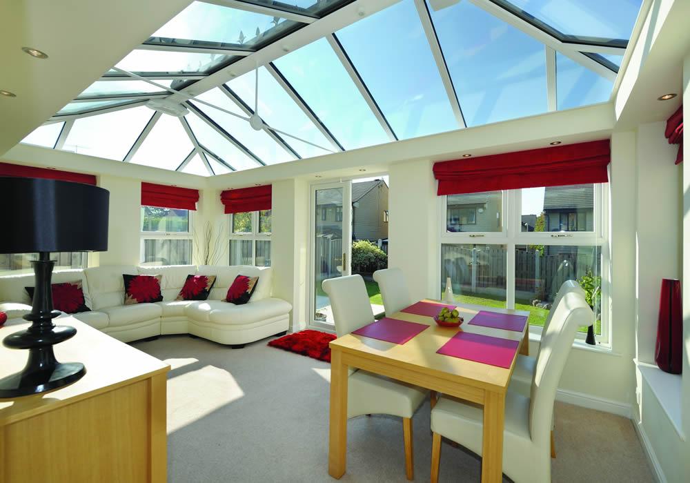 Orangery interior with a lantern roof above a dining table