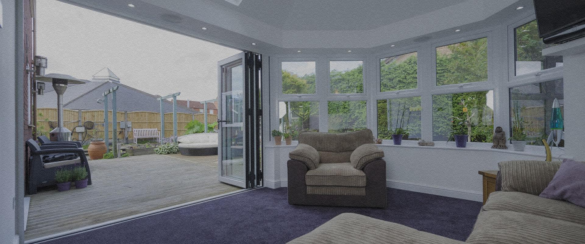 Origin aluminium bifolding doors opening onto a garden