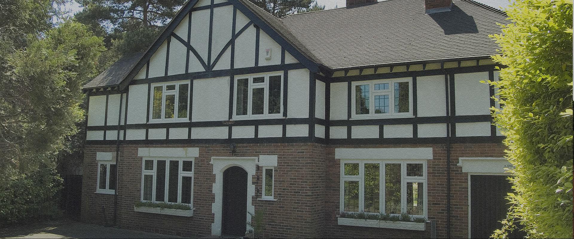 White uPVC windows on a rendered detached house