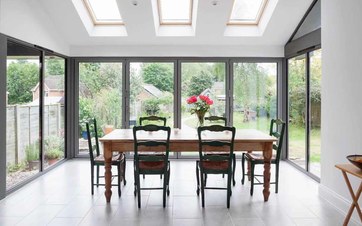 Smart aluminium bifolding doors folded back onto a patio