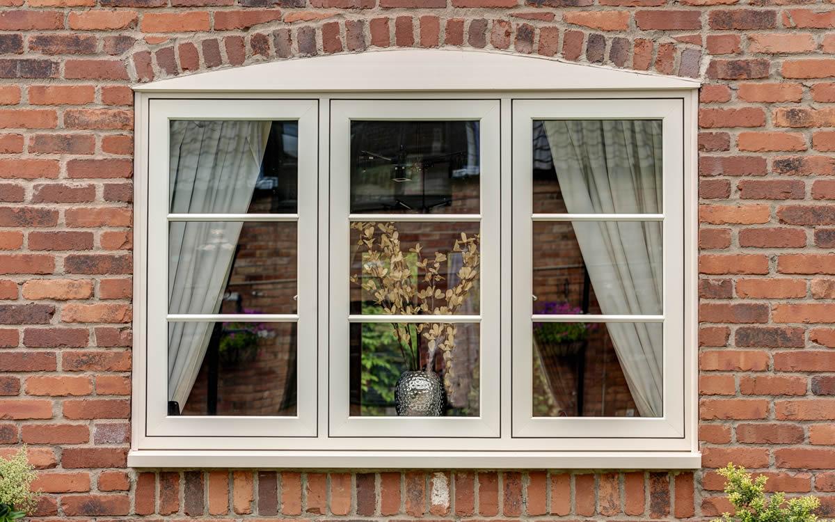 White flush sash windows on a brick cottage